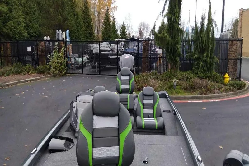 Slide: The Image of 2026 Ranger RT188 boat with green-accented seats, parked near a gated area. - 102