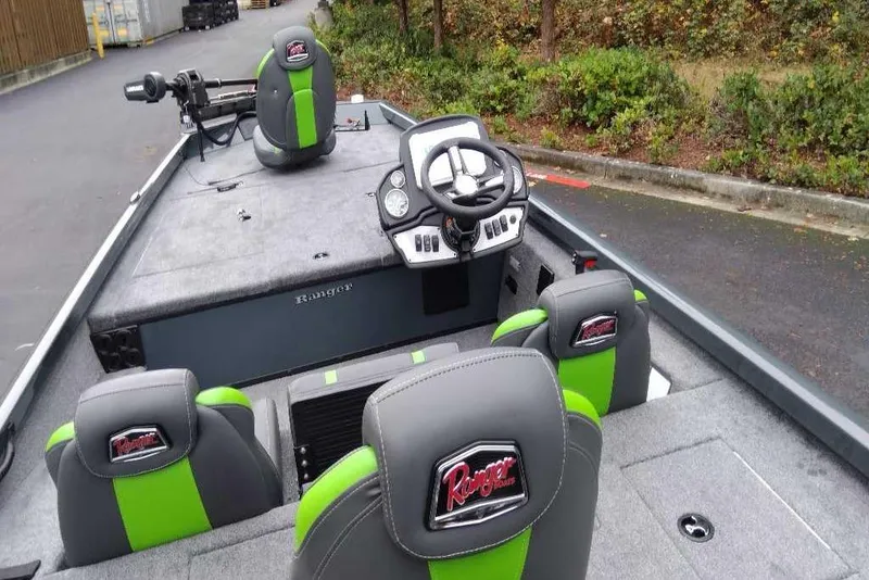 Slide: The Image of 2026 Ranger RT188 boat interior with green and gray seats, steering wheel, and control panel. - 103