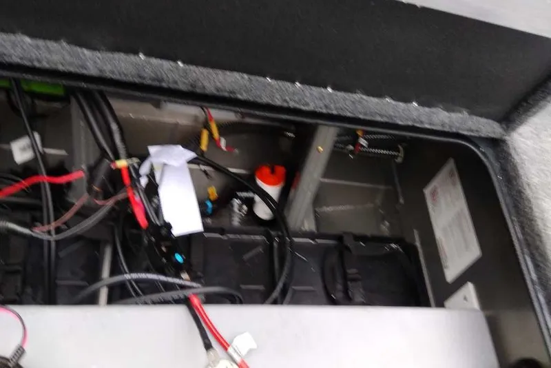 Slide: The Image of Interior view of 2026 Ranger RT188 boat's wiring and battery compartment. - 98