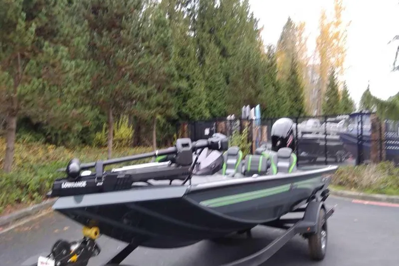 Slide: The Image of 2026 Ranger RT188 boat with green accents parked outdoors. - 99