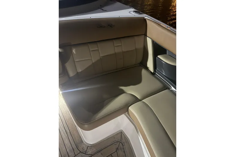 Slide: The Image of 2015 Sea Ray 350 SLX boat interior with tan leather seating at night. - 11