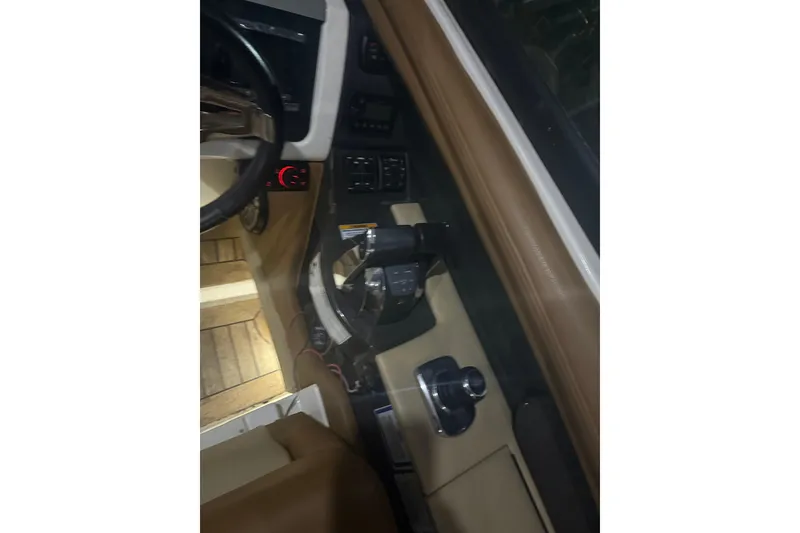 Slide: The Image of Interior view of 2015 Sea Ray 350 SLX boat cockpit with controls and steering wheel. - 13