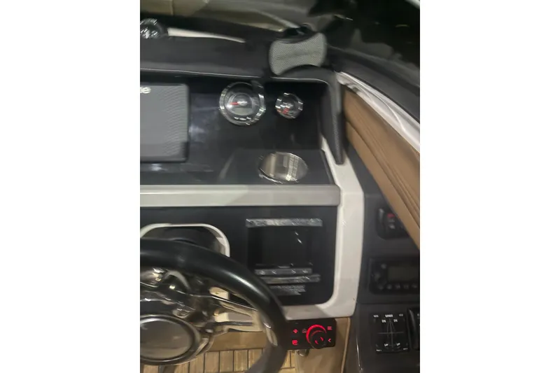 Slide: The Image of Cockpit view of 2015 Sea Ray 350 SLX boat with steering wheel and controls. - 17