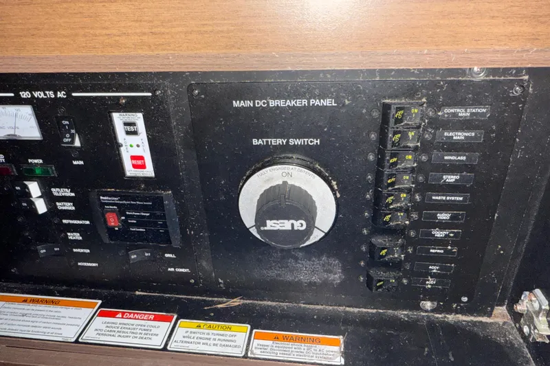 Slide: The Image of Control panel of a 2015 Sea Ray 350 SLX boat with various switches and warnings. - 19