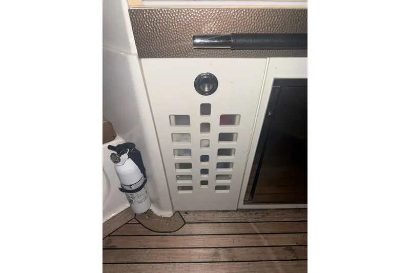 Slide: The Image of 2015 Sea Ray 350 SLX interior with fire extinguisher and vented panel. - 23