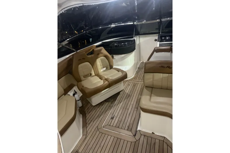 Slide: The Image of 2015 Sea Ray 350 SLX boat interior with tan seating and wood flooring. - 9