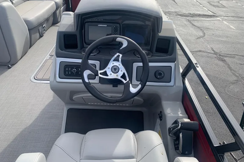 Slide: The Image of 2024 Regency 250 DL3 boat dashboard with steering wheel and navigation system. - 3
