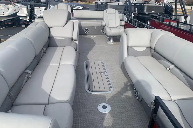 Slide: The Image of 2024 Regency 250 DL3 pontoon boat interior with plush seating and spacious layout. - 4