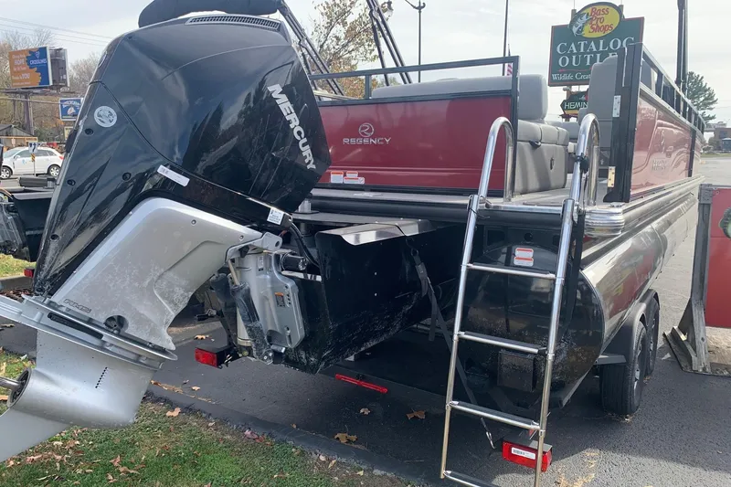 Slide: The Image of 2024 Regency 250 DL3 pontoon boat with Mercury outboard motor and boarding ladder. - 6