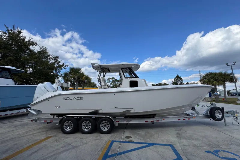 Slide: The Image of 2026 Solace 32 CS boat on trailer under blue sky with clouds. - 10