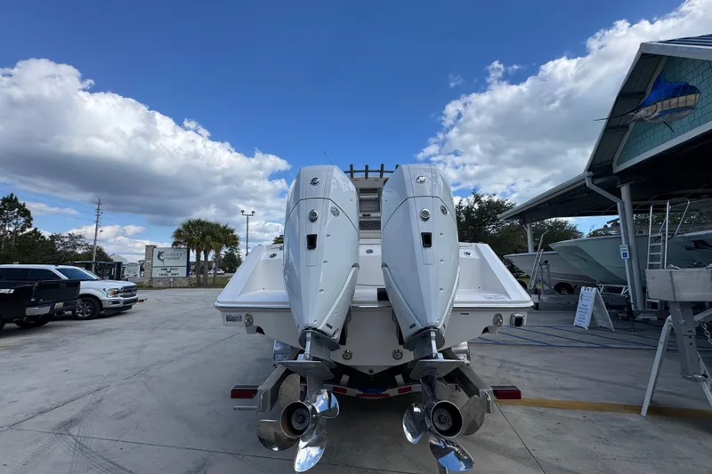 Slide: The Image of 2026 Solace 32 CS boat with dual outboard engines in a marina setting. - 13