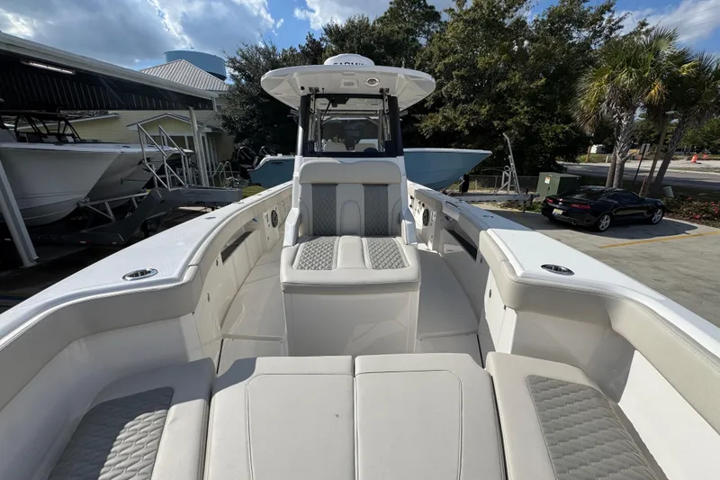 Slide: The Image of 2026 Solace 32 CS boat with spacious seating and modern design in a marina setting. - 22