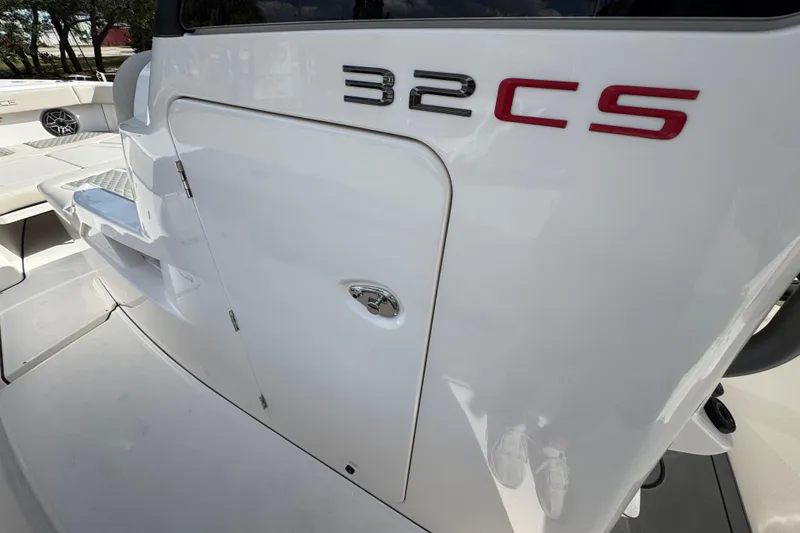 Slide: The Image of 2026 Solace 32 CS boat, sleek white exterior with model branding. - 25
