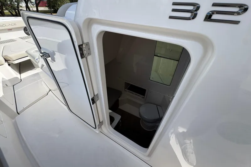 Slide: The Image of 2026 Solace 32 CS boat cabin interior with open door, showcasing compact amenities. - 26