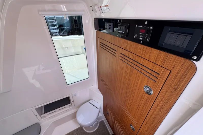 Slide: The Image of 2026 Solace 32 CS boat interior with wooden cabinetry and modern control panels. - 27
