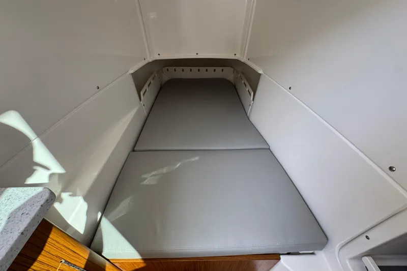 Slide: The Image of 2026 Solace 32 CS cabin interior with cushioned sleeping area. - 29