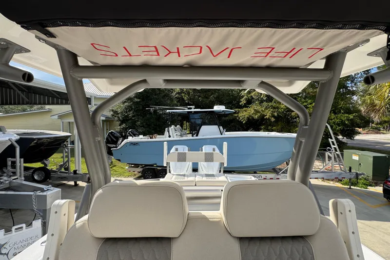 Slide: The Image of 2026 Solace 32 CS boat interior with life jackets, parked outdoors. - 36