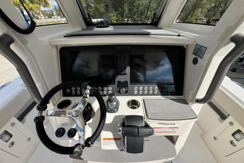 Slide: The Image of Helm of 2026 Solace 32 CS boat with modern controls and navigation screens. - 39