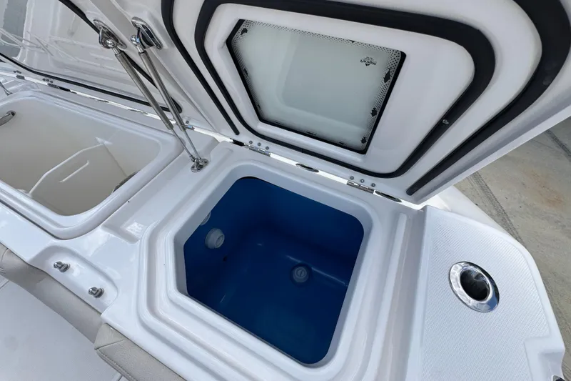 Slide: The Image of 2026 Solace 32 CS boat storage compartments with open lids, showcasing interior design. - 52