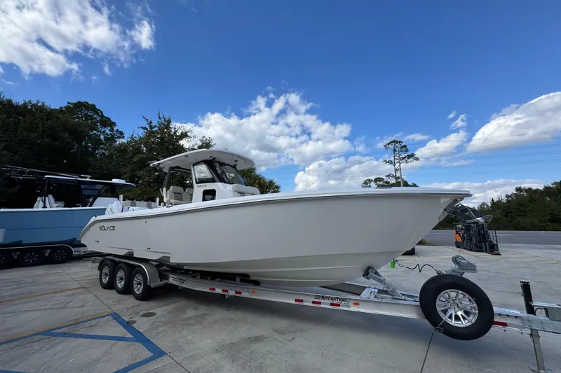 Slide: The Image of 2026 Solace 32 CS boat on trailer under blue sky. - 8