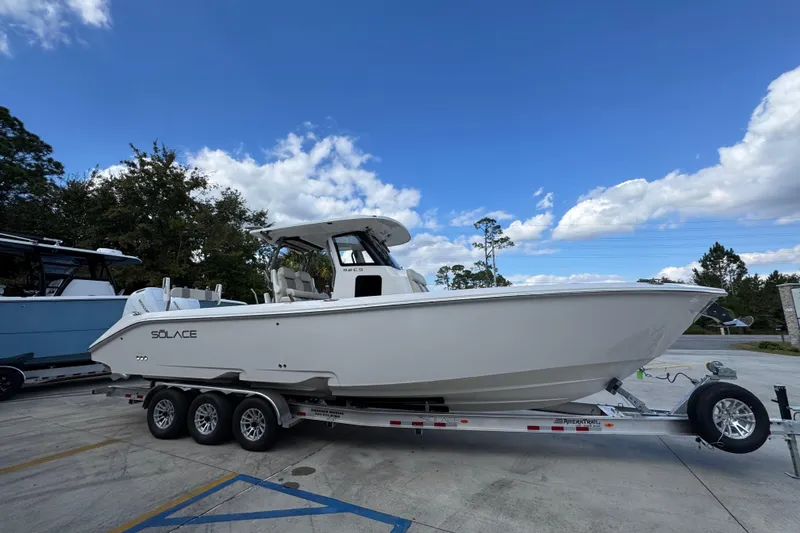 Slide: The Image of 2026 Solace 32 CS boat on trailer under blue sky. - 9