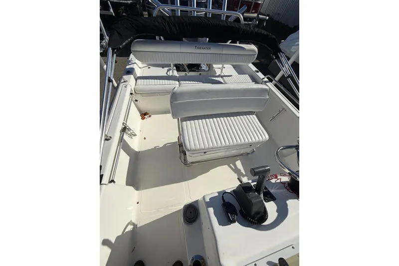 Slide: The Image of 2008 Tidewater 2100 Bay Max boat interior with white seating and control console. - 10