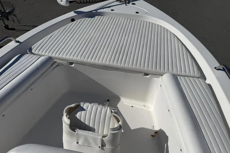 Slide: The Image of 2008 Tidewater 2100 Bay Max boat interior with white cushioned seating. - 15