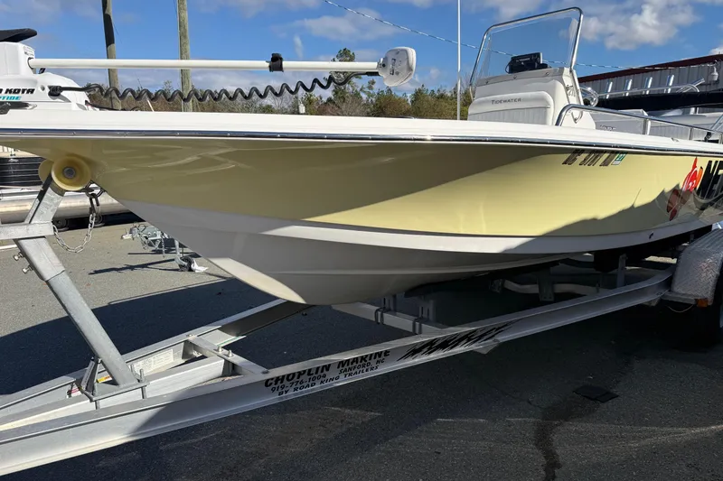 Slide: The Image of 2008 Tidewater 2100 Bay Max boat on trailer, yellow hull, outdoor setting. - 18