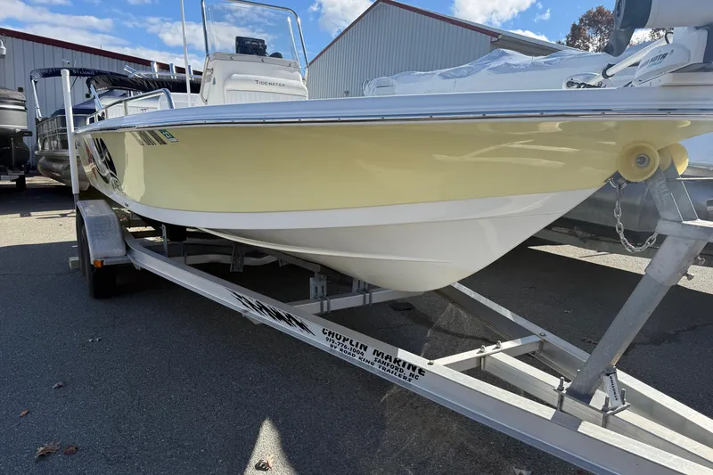 Slide: The Image of 2008 Tidewater 2100 Bay Max boat on trailer, parked outdoors near a warehouse. - 19