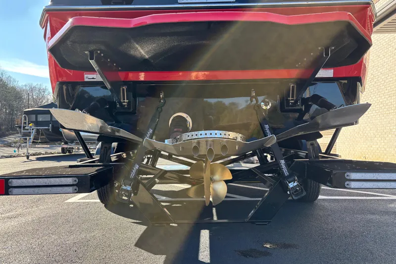 Slide: The Image of 2026 Supreme S240 boat stern with propeller and wakeboard features in sunlight. - 4