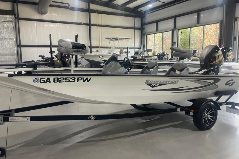 The Image of 2022 G3 Sportsman 1710 Vinyl boat in showroom, side view. - 2