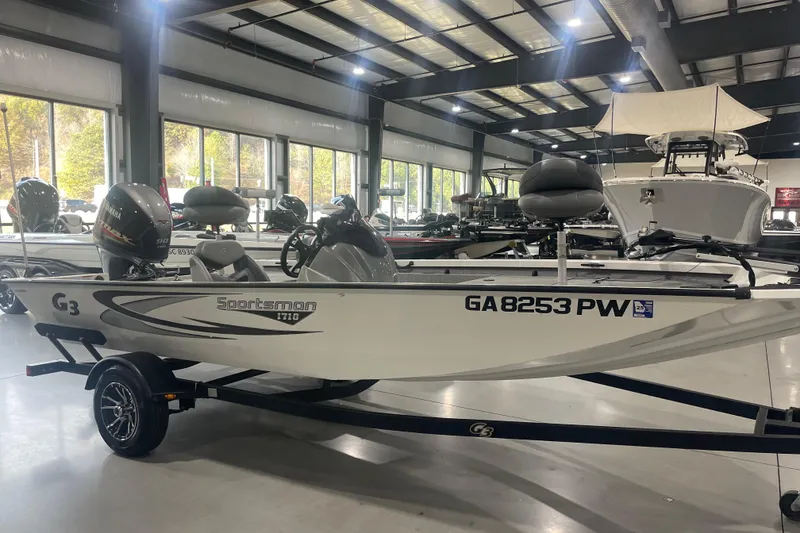Slide: The Image of 2022 G3 Sportsman 1710 Vinyl boat displayed indoors on a trailer. - 9