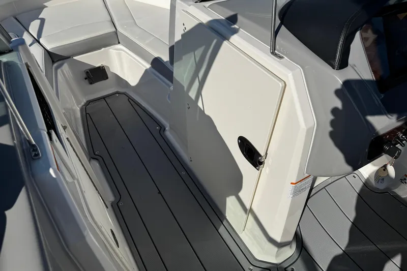 Slide: The Image of 2024 Chaparral 21 SSi OB boat interior with seating and storage compartment. - 11