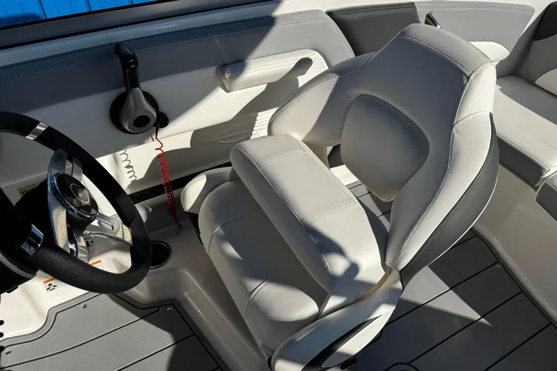 Slide: The Image of 2024 Chaparral 21 SSi OB boat interior with steering wheel and plush seating. - 13