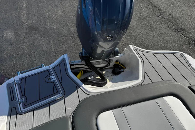 Slide: The Image of 2024 Chaparral 21 SSi OB boat with sleek deck and powerful outboard motor. - 19