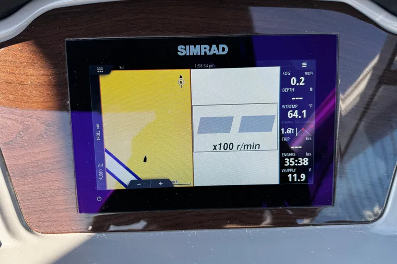 Slide: The Image of Simrad display on 2024 Chaparral 21 SSi OB boat dashboard showing navigation data. - 24