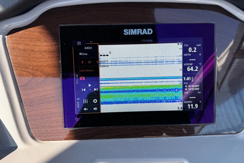 Slide: The Image of Simrad display on 2024 Chaparral 21 SSi OB showing navigation and audio controls. - 29