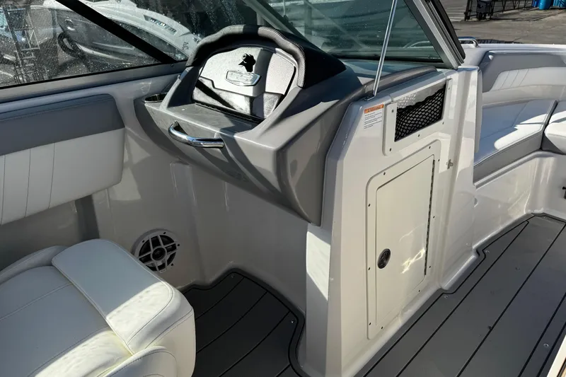 Slide: The Image of 2024 Chaparral 21 SSi OB boat interior with steering wheel and seating. - 31
