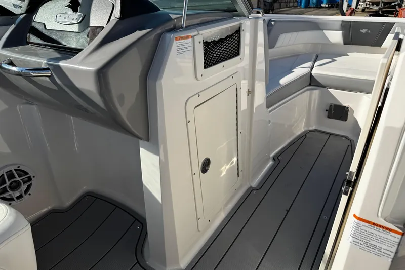 Slide: The Image of 2024 Chaparral 21 SSi OB boat interior with seating and storage compartment. - 32