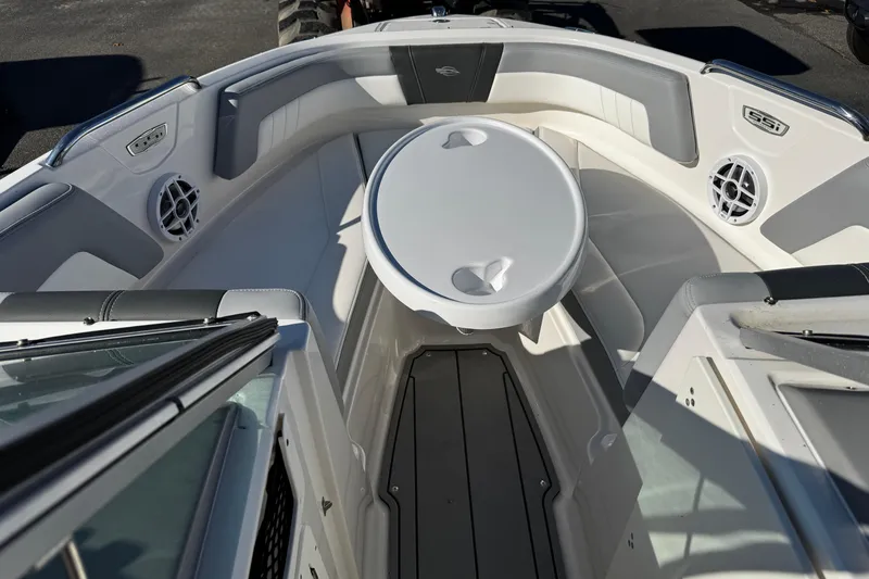 Slide: The Image of 2024 Chaparral 21 SSi OB boat interior with seating and table in the bow area. - 37