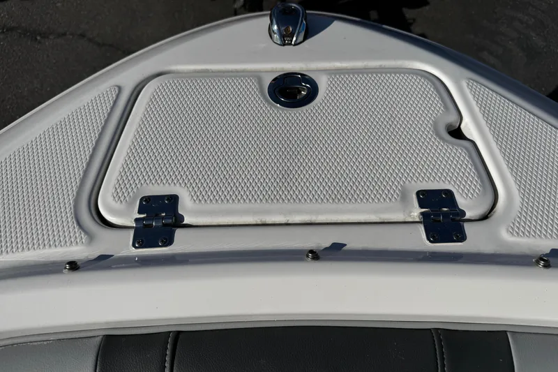 Slide: The Image of 2024 Chaparral 21 SSi OB boat hatch with textured surface and metal hinges. - 41