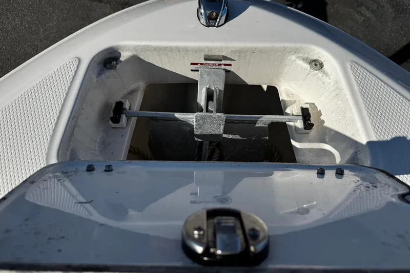 Slide: The Image of 2024 Chaparral 21 SSi OB boat anchor compartment with open hatch. - 42