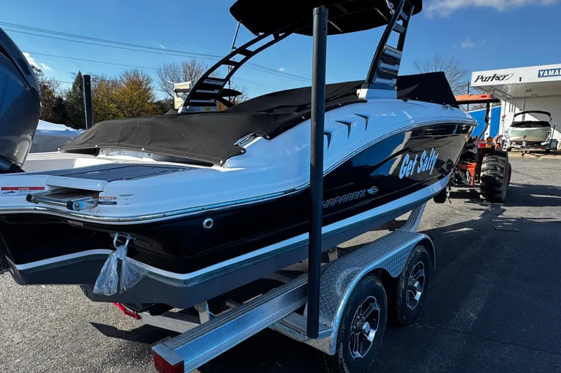 Slide: The Image of 2024 Chaparral 21 SSi OB boat on trailer, black and white design, outdoor setting. - 5