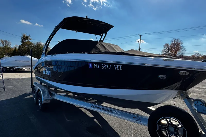 Slide: The Image of 2024 Chaparral 21 SSi OB boat on trailer, black hull, outdoor display. - 6