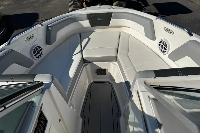 Slide: The Image of 2024 Chaparral 21 SSi OB boat interior with white seating and speakers. - 8