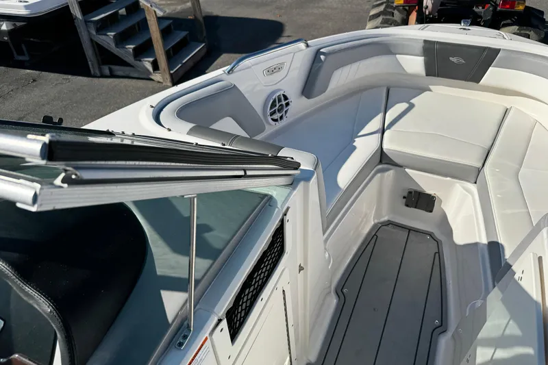 Slide: The Image of 2024 Chaparral 21 SSi OB boat interior with white seating and sleek design. - 9