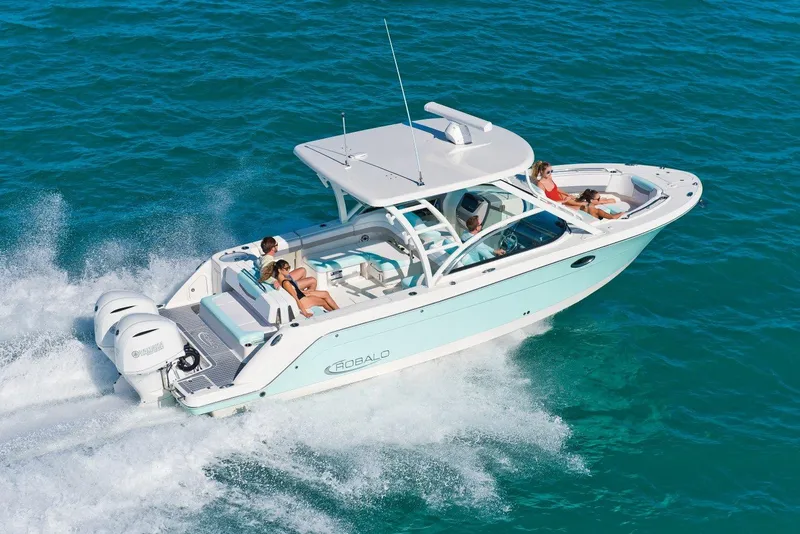 The Image of Manufacturer Provided Image: 2025 Robalo R317 Dual Console cruising on clear blue water. - 0