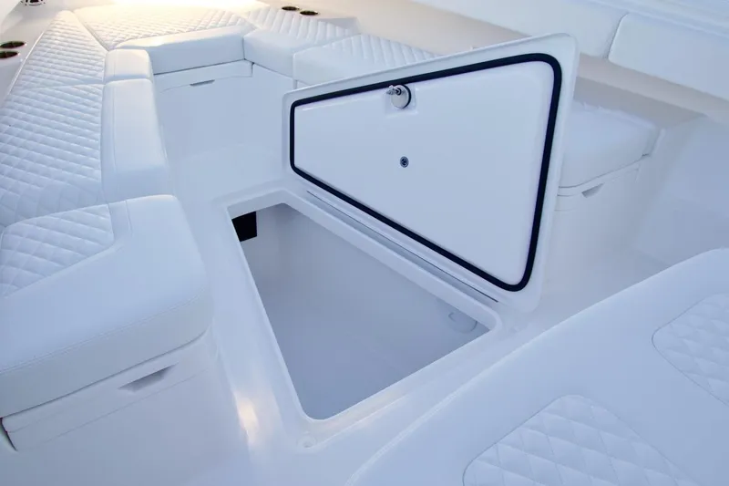 Slide: The Image of 2026 Regulator 31 boat interior with open storage compartment and quilted seating. - 10