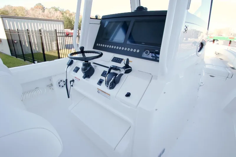 Slide: The Image of 2026 Regulator 31 boat cockpit with steering wheel and dual screens. - 14