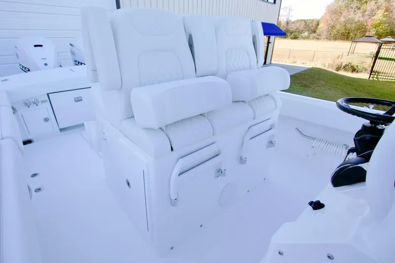 Slide: The Image of 2026 Regulator 31 boat interior with plush white seating and steering wheel. - 16